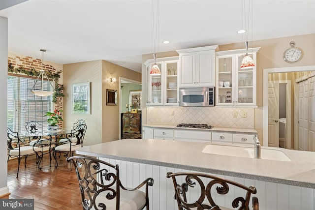 176 Windgate Dr, Chester Springs, PA 19425 - kitchen featuring stainless steel appliances, backsplash, wood-type flooring, light countertops, and white cabinetry