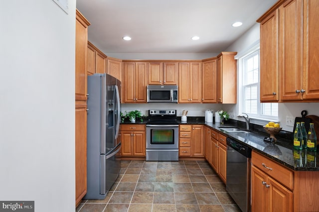 1201 Preserve Ln, Fredericksburg, VA 22401 - kitchen with stainless steel appliances, recessed lighting, dark stone countertops, and brown cabinetry