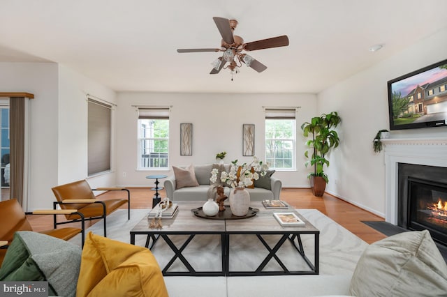 1201 Preserve Ln, Fredericksburg, VA 22401 - living area with wood finished floors, a ceiling fan, and a fireplace with flush hearth