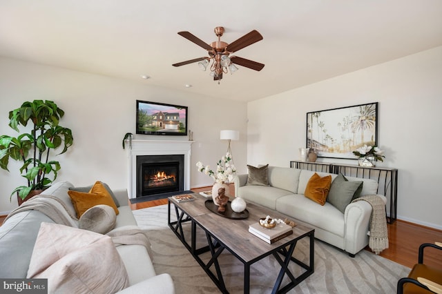 1201 Preserve Ln, Fredericksburg, VA 22401 - living room with light wood-style flooring, ceiling fan, and a fireplace with flush hearth