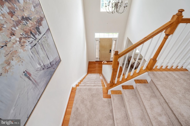 1201 Preserve Ln, Fredericksburg, VA 22401 - stairs featuring a chandelier, a towering ceiling, and wood finished floors