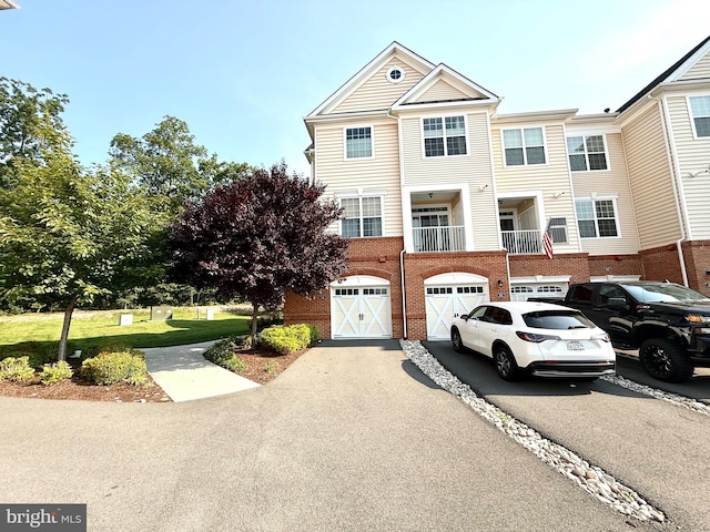 23245 Milltown Knoll Sq Unit 103, Ashburn, VA 20148 - view of front of home featuring driveway, an attached garage, and brick siding