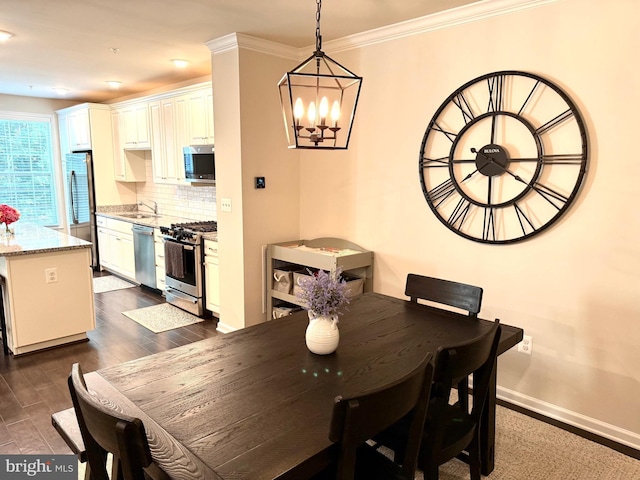 23245 Milltown Knoll Sq Unit 103, Ashburn, VA 20148 - dining space featuring a chandelier, dark wood-style flooring, and crown molding