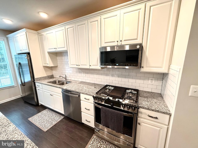 23245 Milltown Knoll Sq Unit 103, Ashburn, VA 20148 - kitchen with appliances with stainless steel finishes, dark wood-style floors, backsplash, and light stone countertops