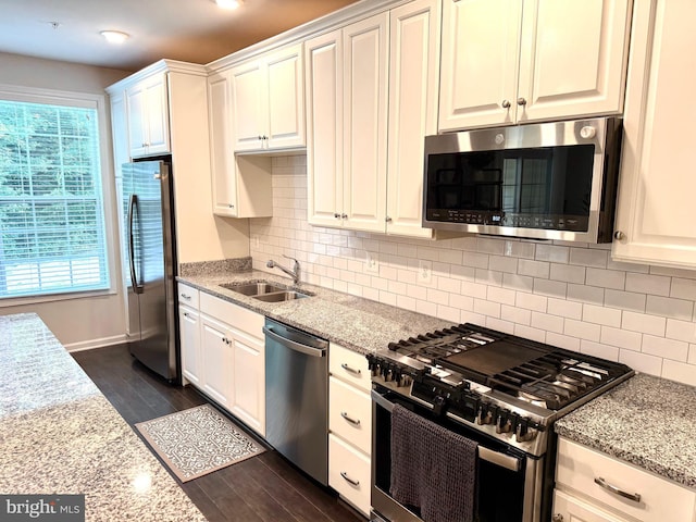 23245 Milltown Knoll Sq Unit 103, Ashburn, VA 20148 - kitchen featuring stainless steel appliances, light stone counters, white cabinets, and decorative backsplash