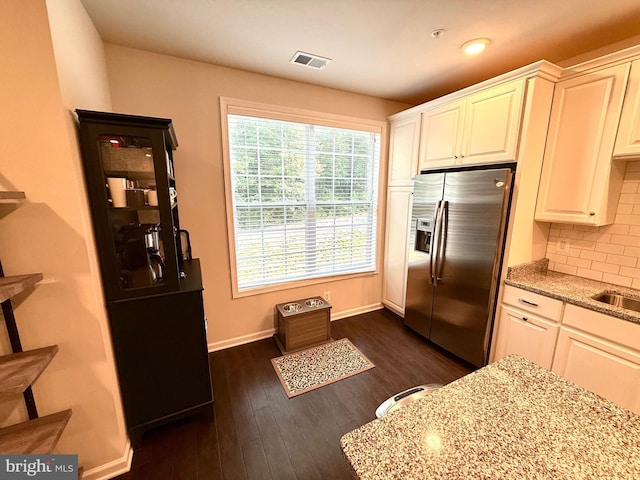 23245 Milltown Knoll Sq Unit 103, Ashburn, VA 20148 - kitchen featuring stainless steel fridge with ice dispenser, light stone counters, tasteful backsplash, dark wood-style floors, and white cabinetry