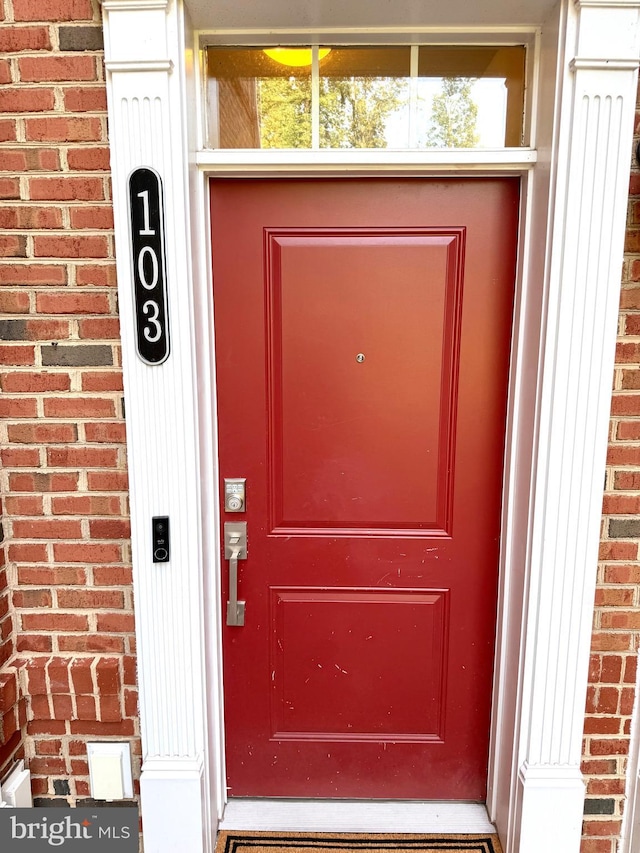 23245 Milltown Knoll Sq Unit 103, Ashburn, VA 20148 - doorway to property featuring brick siding