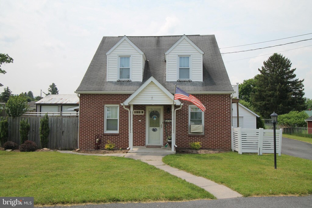 120 Middle St, Bellefonte, PA 16823 - cape cod home featuring brick siding and roof with shingles