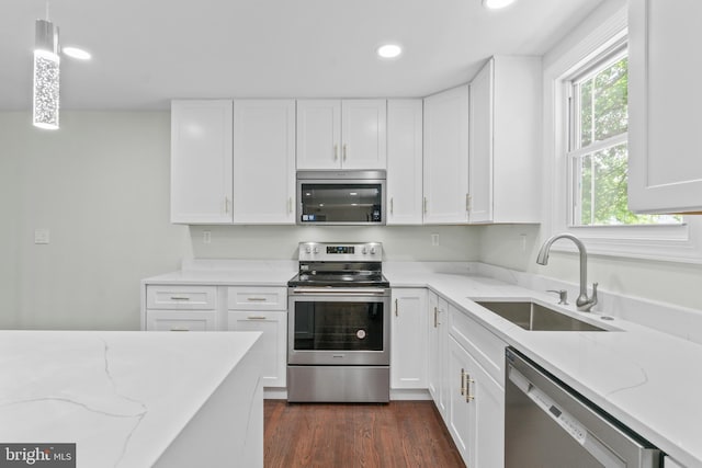 7724 Central Ave, Pasadena, MD 21122 - kitchen featuring stainless steel appliances, recessed lighting, white cabinets, and light stone counters
