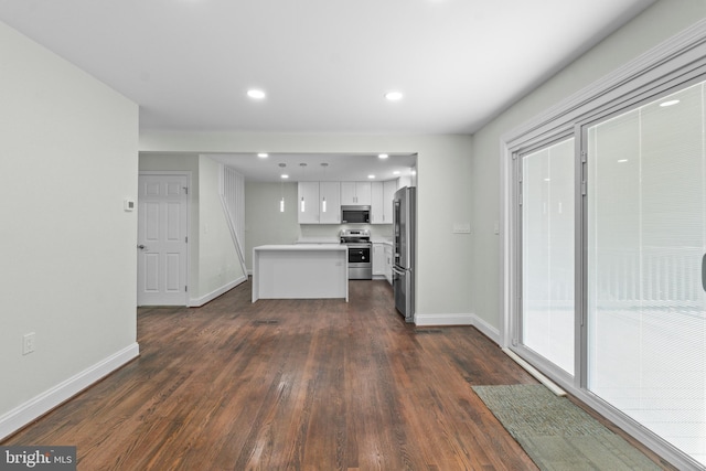 7724 Central Ave, Pasadena, MD 21122 - kitchen featuring stainless steel appliances, light countertops, dark wood-type flooring, white cabinets, and pendant lighting