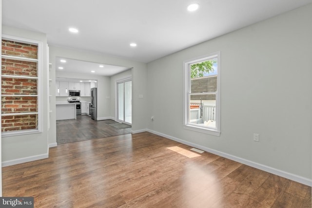 7724 Central Ave, Pasadena, MD 21122 - unfurnished living room with dark wood-type flooring and recessed lighting