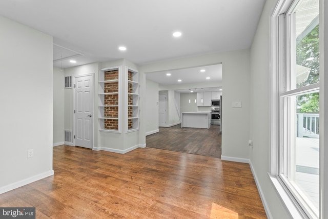 7724 Central Ave, Pasadena, MD 21122 - unfurnished living room with wood finished floors, attic access, and recessed lighting