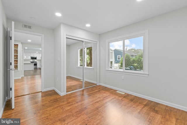 7724 Central Ave, Pasadena, MD 21122 - unfurnished bedroom with wood finished floors, recessed lighting, and a closet