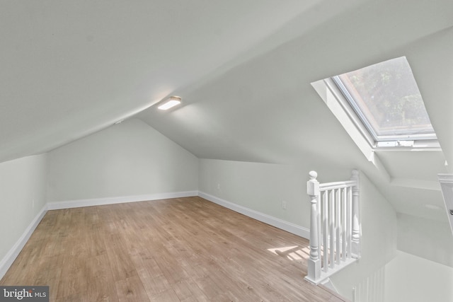 7724 Central Ave, Pasadena, MD 21122 - additional living space with a skylight, light wood-style floors, and lofted ceiling