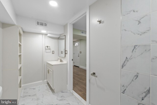 7724 Central Ave, Pasadena, MD 21122 - bathroom with vanity and marble look tiles