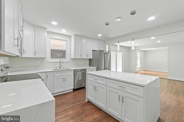 7724 Central Ave, Pasadena, MD 21122 - kitchen featuring appliances with stainless steel finishes, a kitchen island, white cabinetry, dark wood-style flooring, and recessed lighting