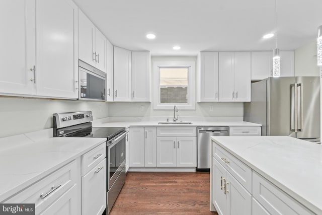 7724 Central Ave, Pasadena, MD 21122 - kitchen with stainless steel appliances, white cabinets, dark wood finished floors, recessed lighting, and light stone counters