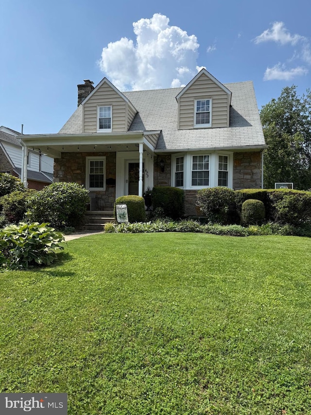 620 Laurel Rd, Springfield, PA 19064 - view of front facade featuring stone siding, a front yard, a chimney, and a porch