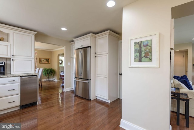 620 Laurel Rd, Springfield, PA 19064 - kitchen featuring freestanding refrigerator, dark wood-type flooring, recessed lighting, white cabinetry, and arched walkways