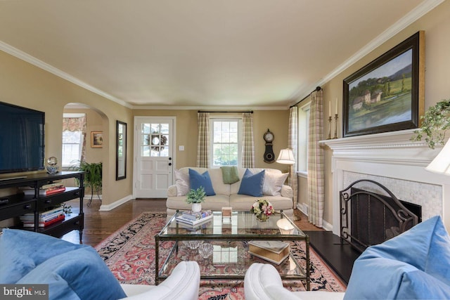 620 Laurel Rd, Springfield, PA 19064 - living area with arched walkways, a fireplace, crown molding, and wood finished floors