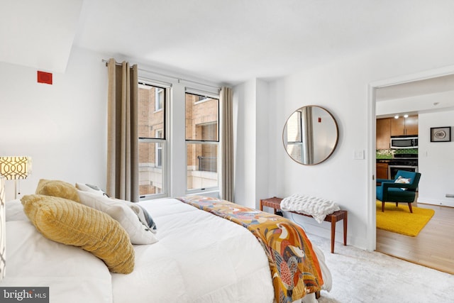 915 E St NW Unit 1103, Washington, DC 20004 - bedroom featuring wood finished floors and baseboards