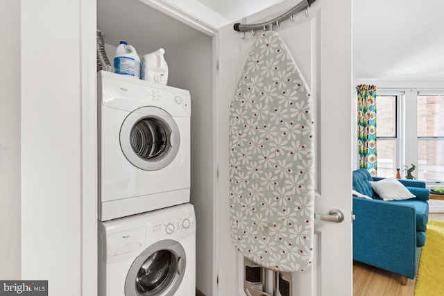 915 E St NW Unit 1103, Washington, DC 20004 - washroom featuring stacked washing machine and dryer and wood finished floors
