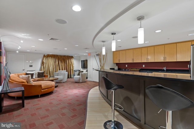 915 E St NW Unit 1103, Washington, DC 20004 - kitchen featuring dark countertops, open floor plan, a breakfast bar area, light carpet, and recessed lighting