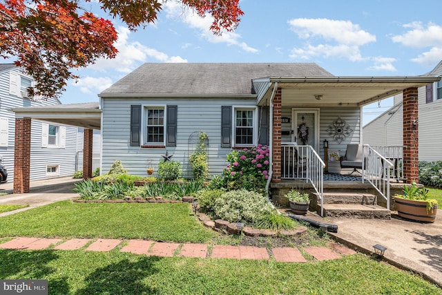 1815 Belle Ave, Dundalk, MD 21222 - view of front of home with roof with shingles, a front lawn, and covered porch