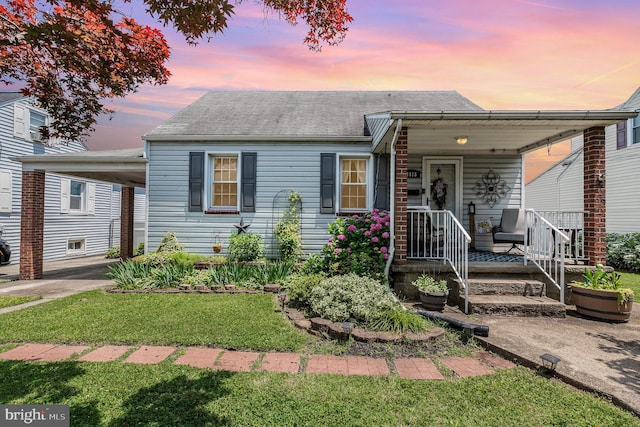 1815 Belle Ave, Dundalk, MD 21222 - view of front of home with a shingled roof, a yard, and covered porch