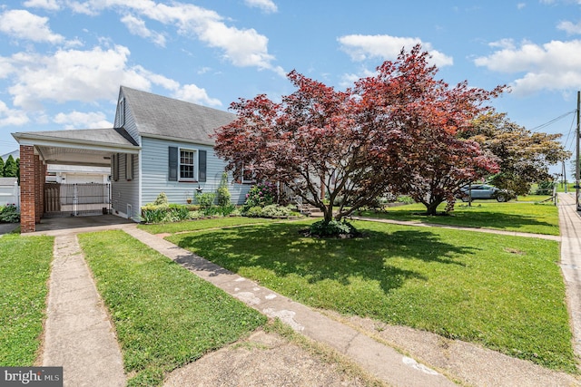 1815 Belle Ave, Dundalk, MD 21222 - view of front of house with driveway, roof with shingles, an attached carport, and a gate