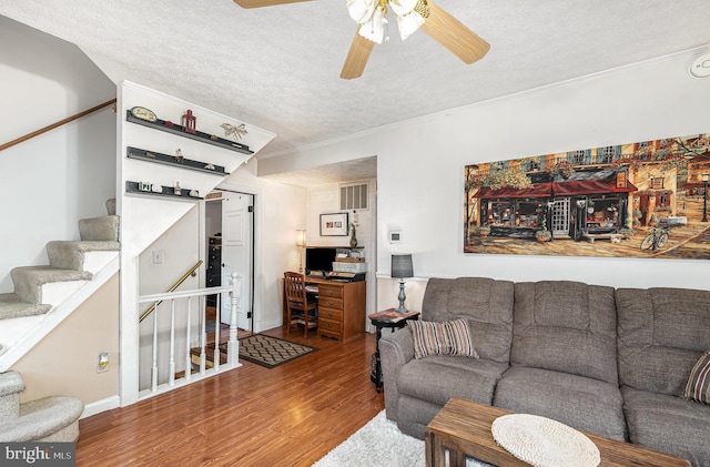1815 Belle Ave, Dundalk, MD 21222 - living area with a textured ceiling, wood finished floors, ceiling fan, stairway, and crown molding