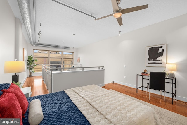 1390 Kenyon St NW Unit 524, Washington, DC 20010 - bedroom with wood finished floors and a textured ceiling