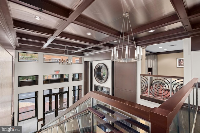 1390 Kenyon St NW Unit 524, Washington, DC 20010 - stairs with coffered ceiling, stacked washer / dryer, a chandelier, beam ceiling, and recessed lighting