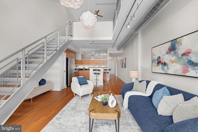 1390 Kenyon St NW Unit 524, Washington, DC 20010 - living room with light wood-style floors and a towering ceiling