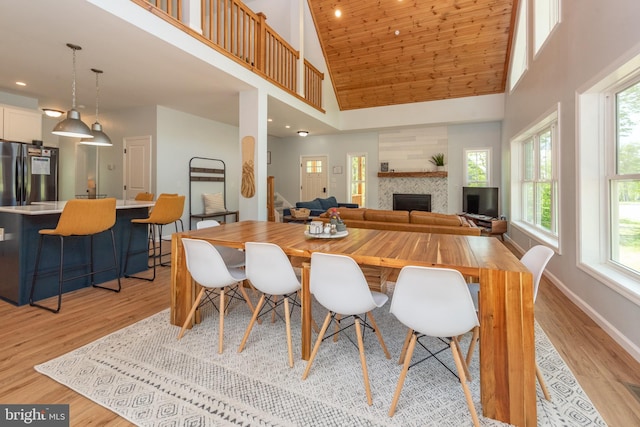 130 Wisp Adventure Rd, Mc Henry, MD 21541 - dining space featuring high vaulted ceiling, a tile fireplace, light wood-style flooring, stairway, and recessed lighting