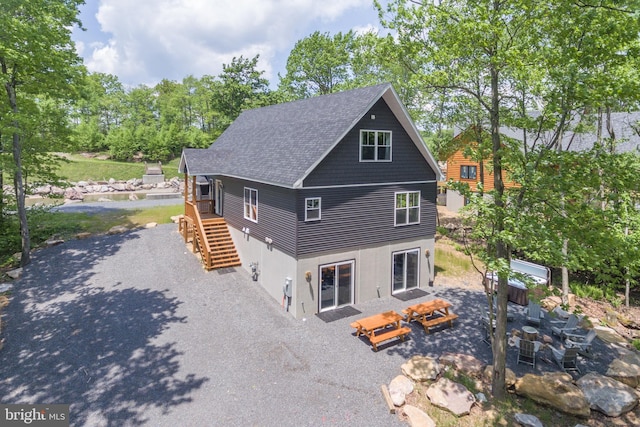 130 Wisp Adventure Rd, Mc Henry, MD 21541 - back of house featuring stairs, a patio area, stucco siding, a shingled roof, and view of wooded area