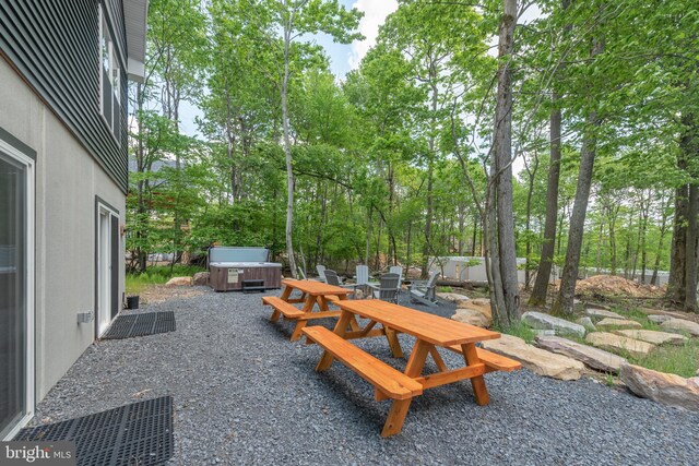 130 Wisp Adventure Rd, Mc Henry, MD 21541 - view of patio / terrace with a hot tub, outdoor dining space, view of wooded area, and grilling area