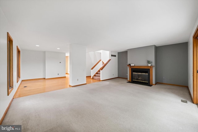 201 Steeplechase Cir, Wilmington, DE 19808 - unfurnished living room with light carpet, stairs, recessed lighting, and a fireplace with flush hearth