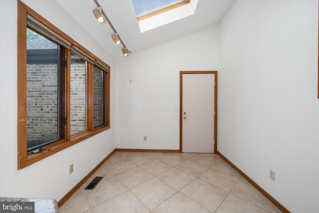 201 Steeplechase Cir, Wilmington, DE 19808 - unfurnished room with a skylight, rail lighting, vaulted ceiling, and light tile patterned floors