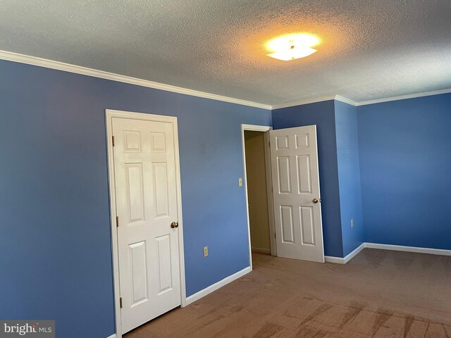 711 E Cork St, Winchester, VA 22601 - unfurnished bedroom featuring carpet flooring, a textured ceiling, and crown molding