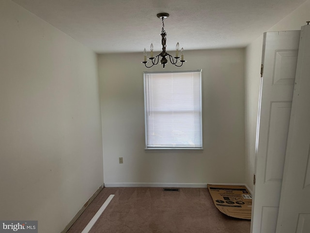711 E Cork St, Winchester, VA 22601 - empty room featuring a chandelier and carpet flooring