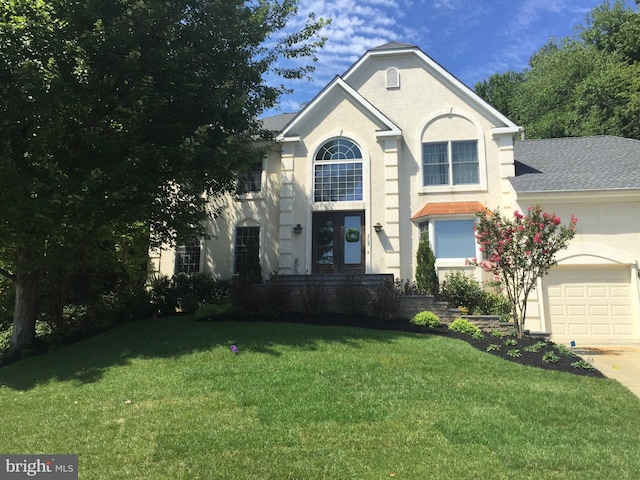 305 Posterity Pl, Marlton, NJ 08053 - view of front of house featuring a front lawn, a garage, driveway, and stucco siding