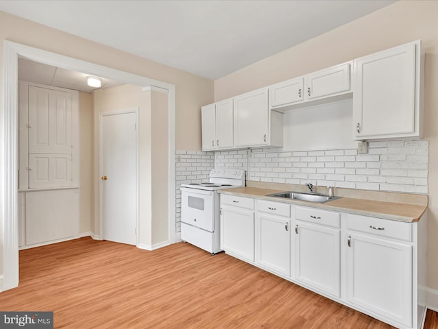 3 S Pine St, Middletown, PA 17057 - kitchen featuring white electric range oven, light wood-style flooring, white cabinets, and light countertops
