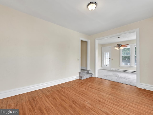 3 S Pine St, Middletown, PA 17057 - unfurnished room with a baseboard heating unit, stairs, ceiling fan, and wood finished floors