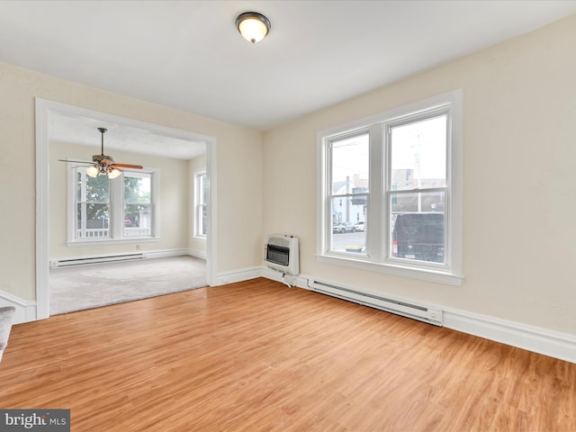 3 S Pine St, Middletown, PA 17057 - unfurnished living room featuring baseboard heating, heating unit, a baseboard radiator, wood finished floors, and ceiling fan