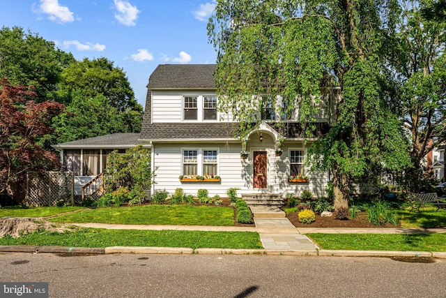 201 Locust St, Moorestown, NJ 08057 - view of front of property with a shingled roof, a front yard, and a sunroom