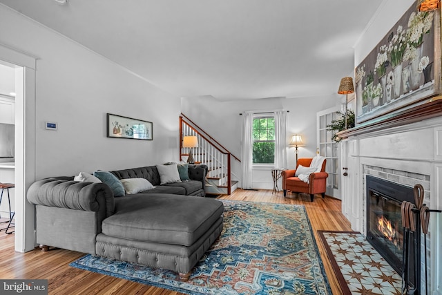 201 Locust St, Moorestown, NJ 08057 - living room featuring stairs, a brick fireplace, and wood finished floors