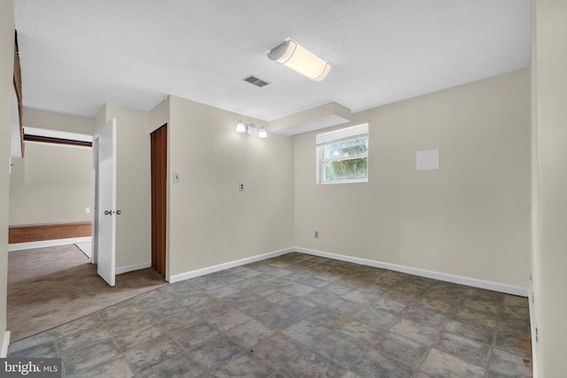 8000 Dellwood Ave, Glenarden, MD 20706 - spare room with baseboards and a textured ceiling