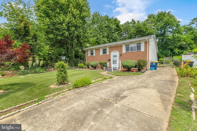8000 Dellwood Ave, Glenarden, MD 20706 - bi-level home featuring brick siding, a front lawn, and driveway