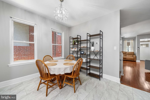 1002 W 9th St, Wilmington, DE 19806 - dining space with baseboards and a chandelier